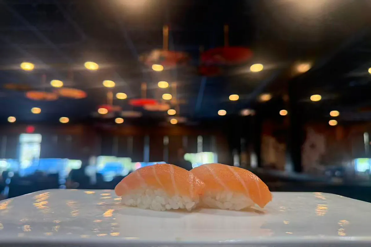 Two pieces of salmon nigiri sushi on white plate at Kings Sushi, a Japanese Restaurant in Summerville